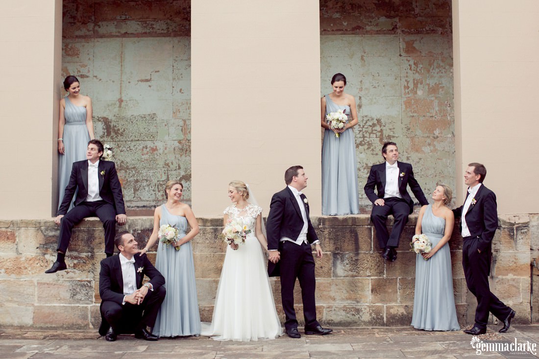 A bridal party posing on a sandstone wall - Sandstone Sydney Wedding