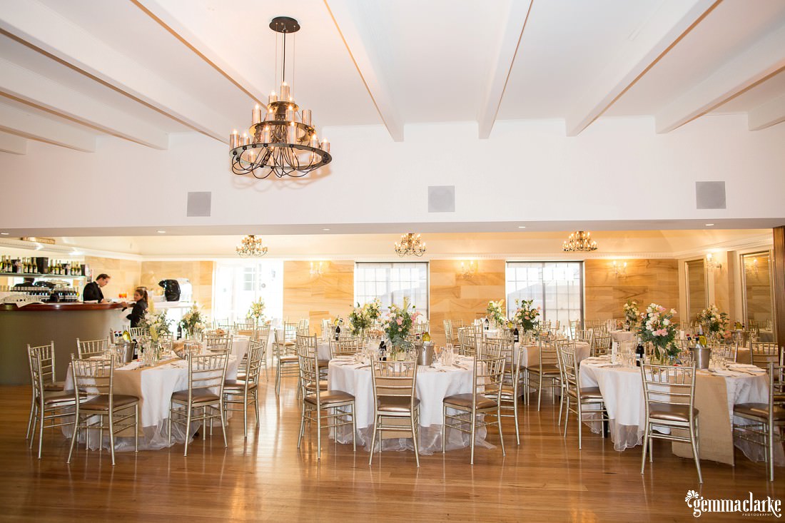 A reception setup with gold chairs and white and oatmeal details - Oatlands House Reception