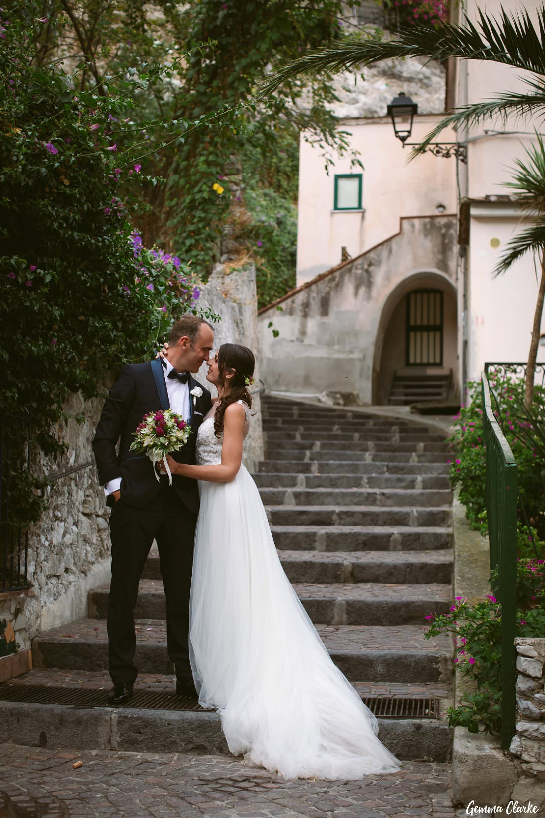 A romantic pose by the stone stairs in the village of Erchie on the Amalfi Coast at this Italian Destination Wedding