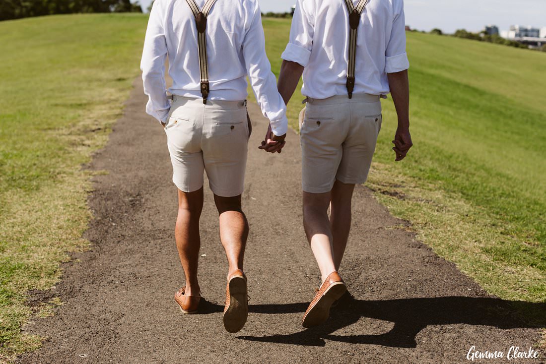 These two grooms walking hand in hand at their Sydney Park wedding