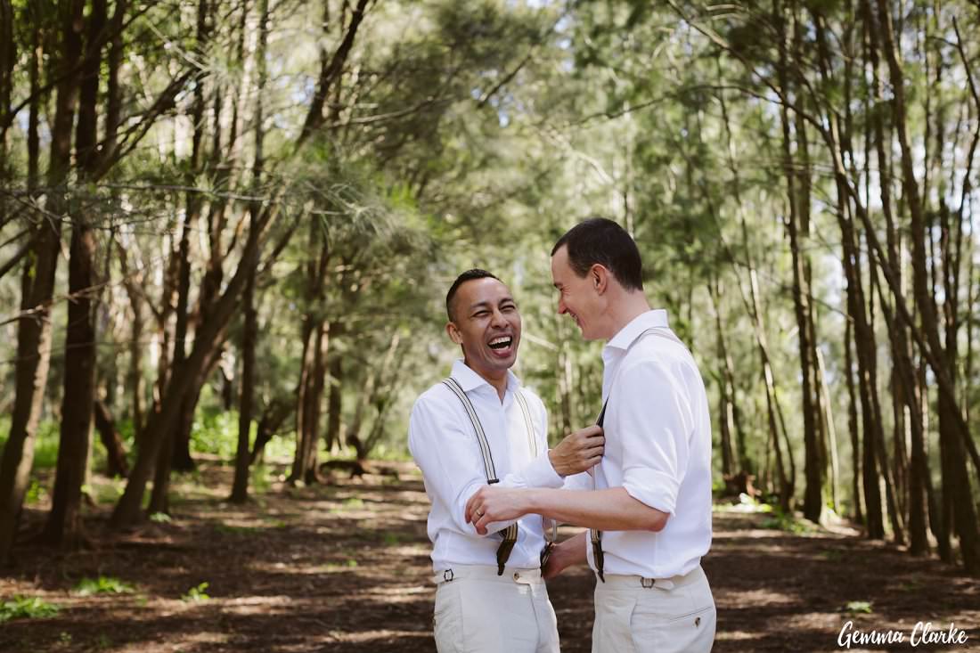 Two grooms being cheeky in the forest at their Sydney Park Wedding